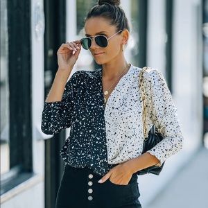 Drape front bodysuit has dolman sleeves, shoulder pleating & shoulder padding